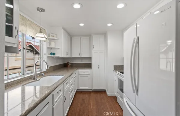 a kitchen with stainless steel appliances granite countertop a refrigerator and a sink