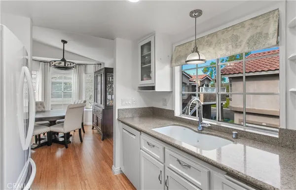a kitchen with sink and refrigerator