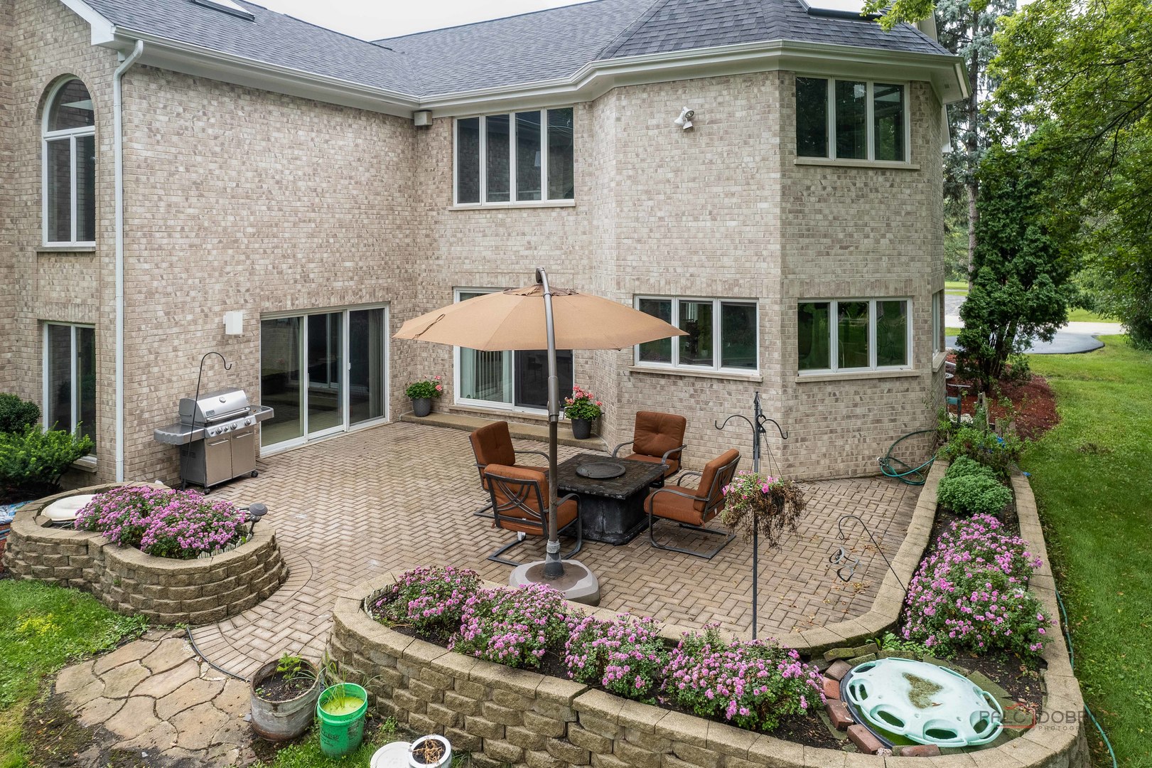 2329 Coach Road Long Grove, IL 60047 - Photo 53 of 56 a front view of a house with table and chairs potted plants