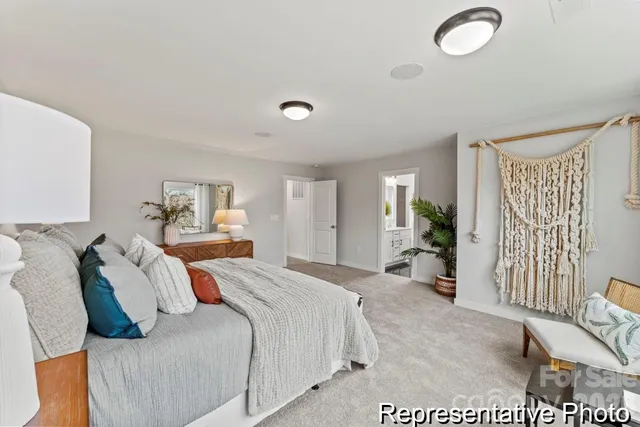 a spacious bedroom with a bed and furniture