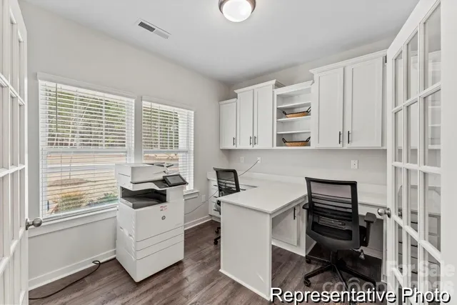 a kitchen with a stove and white cabinets