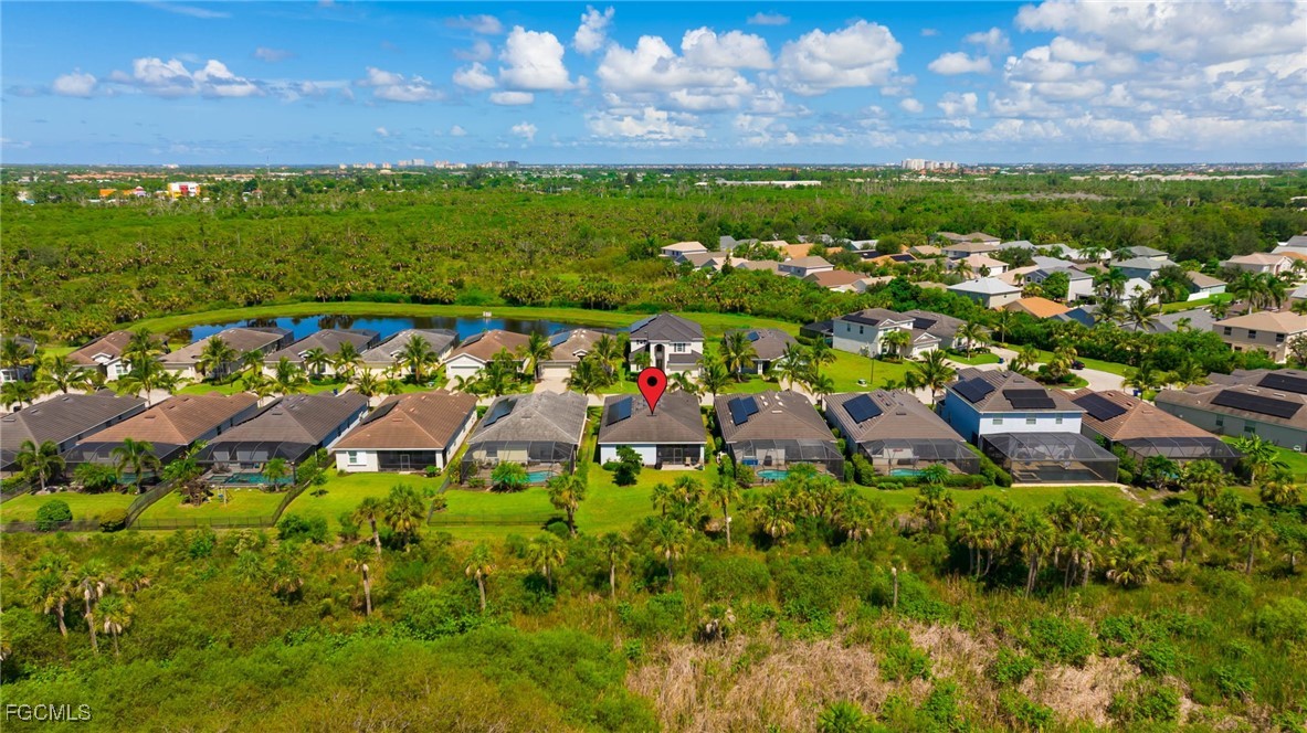 9778 Mirada Boulevard Fort Myers, FL 33908 - Photo 2 of 29 a view of a houses with a lush green forest