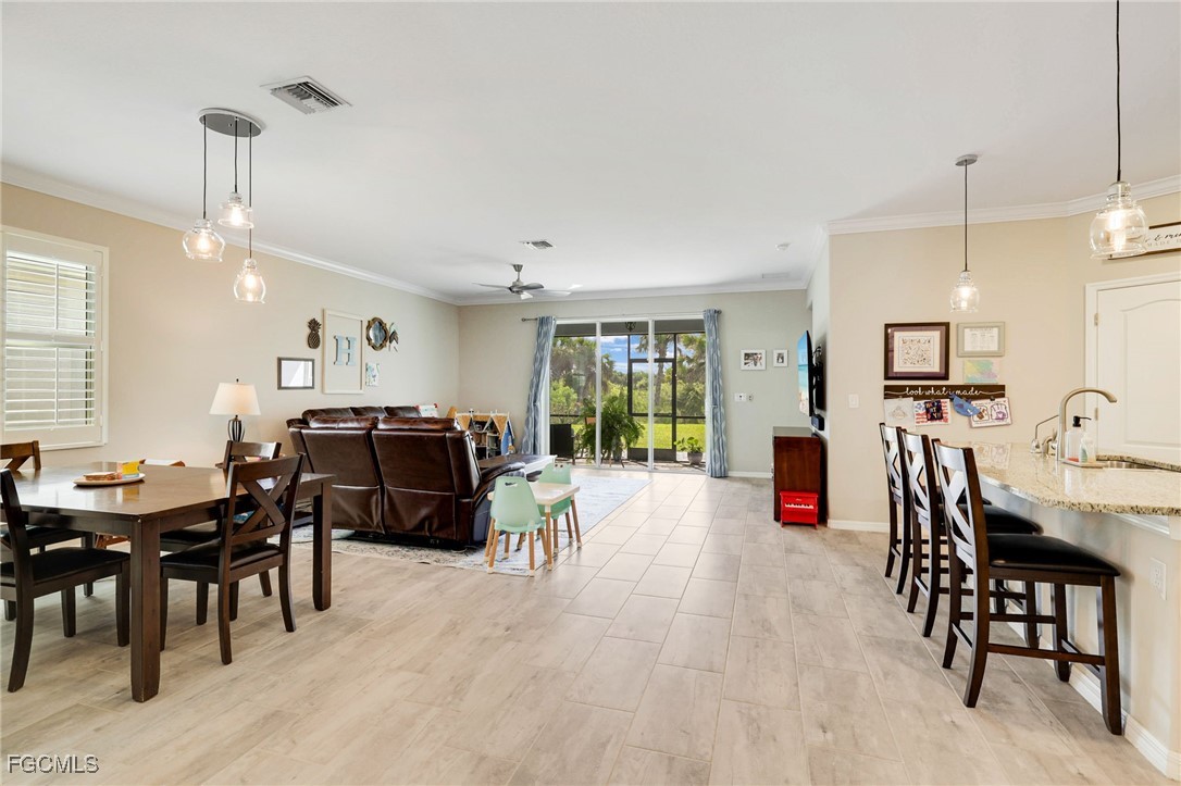 9778 Mirada Boulevard Fort Myers, FL 33908 - Photo 5 of 29 a living room with furniture a fireplace and a chandelier