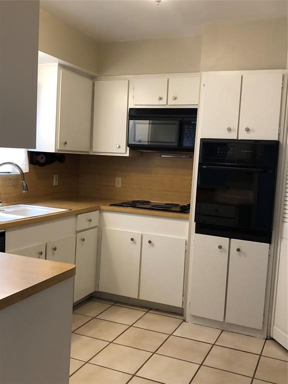 a kitchen with stainless steel appliances a sink and a microwave
