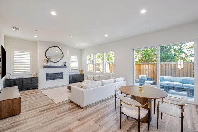 a living room with fireplace furniture and a large window