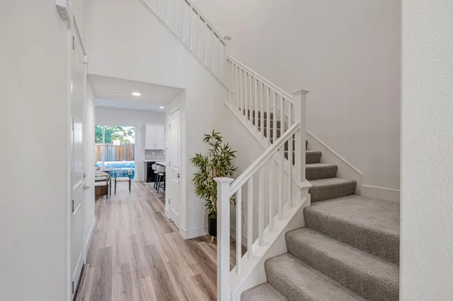 a view of entryway and hall with wooden floor