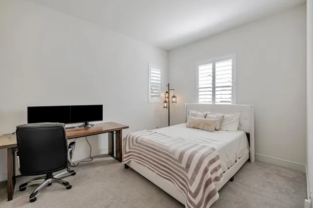 a bedroom with a bed and a desk