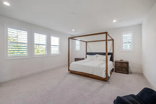 a spacious bedroom with a bed and a window
