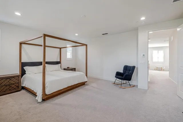 a bedroom with a bed and a chair