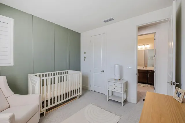 a spacious bedroom with a bed and a couch