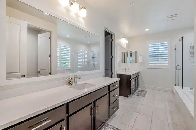a bathroom with a sink double vanity and a mirror