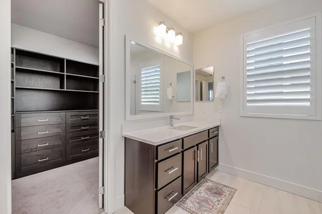 a bathroom with a sink a vanity and a mirror