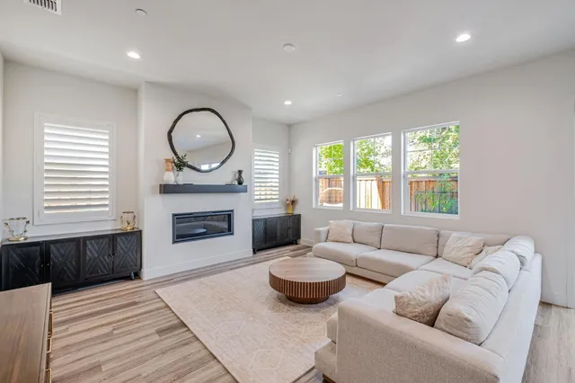 a living room with furniture and a fireplace