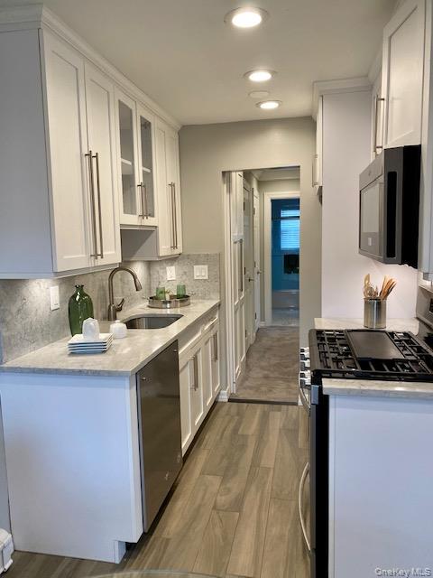 420 Terrace Road, Unit T10420 Bayport, NY 11705 - Photo 4 of 9 a kitchen with stainless steel appliances granite countertop a stove a sink and a refrigerator
