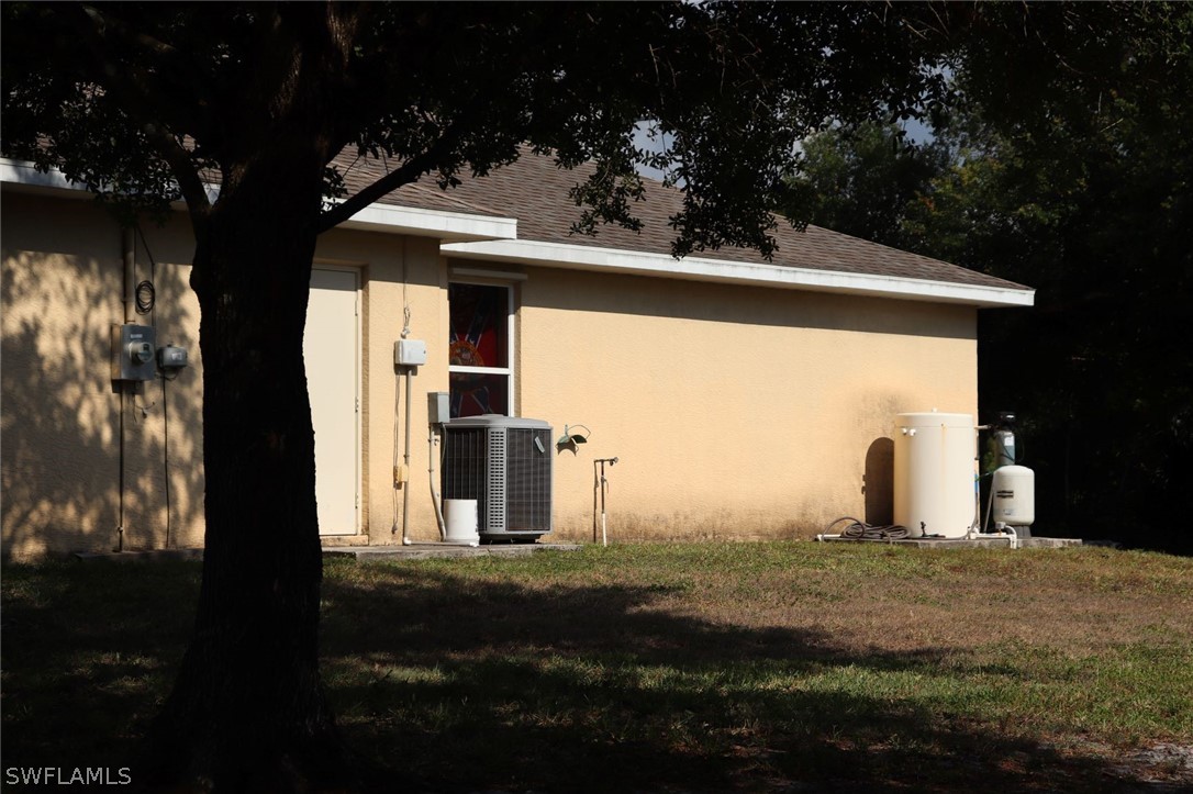 4244 East 24th Street Alva, FL 33920 - Photo 9 of 13 a view of a house with backyard and trees
