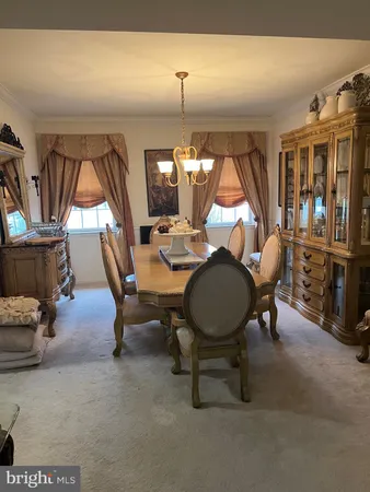 a kitchen with kitchen island a stove a table and chairs in it