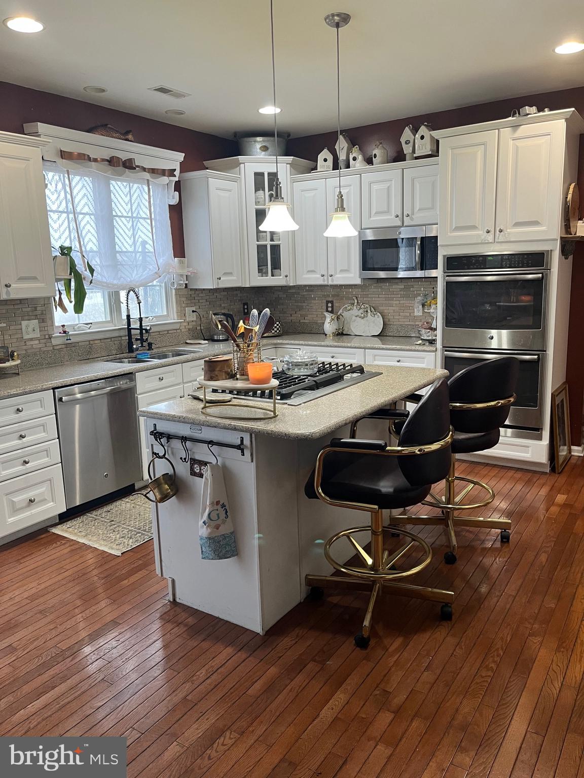 67 Lavender Drive Sewell, NJ 08080 - Photo 10 of 25 a kitchen with kitchen island a stove a table and chairs in it