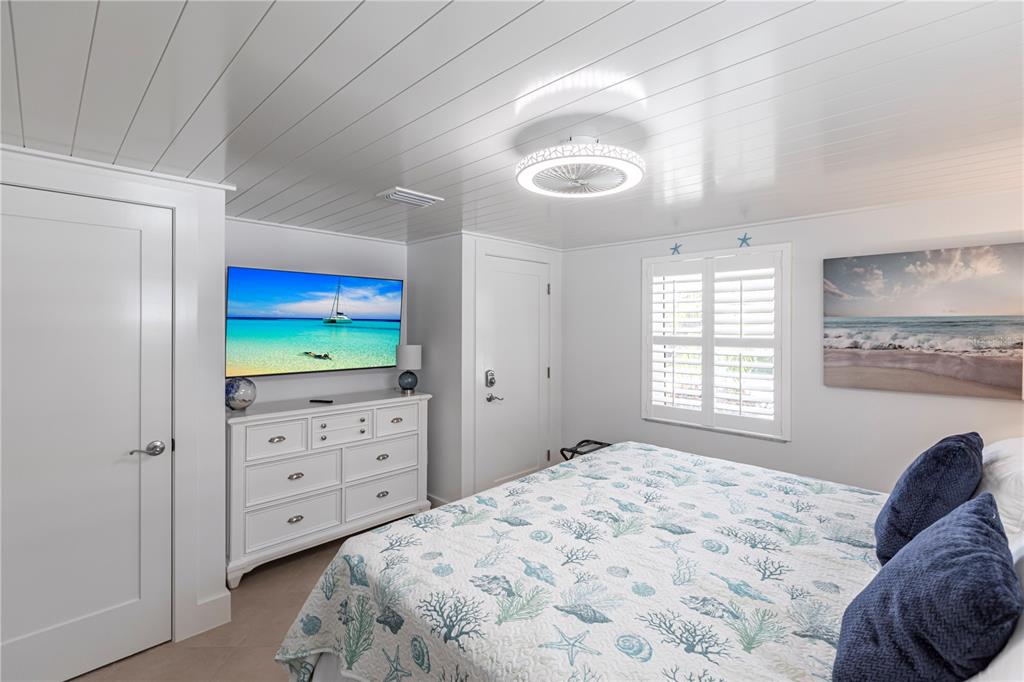6154 Midnight Pass Road, Unit A1 Sarasota, FL 34242 - Photo 13 of 19 a bedroom with a bed and a window