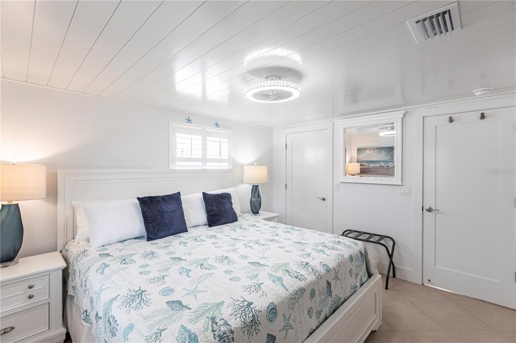 6154 Midnight Pass Road, Unit A1 Sarasota, FL 34242 - Photo 14 of 19 a bedroom with a bed and wooden floor