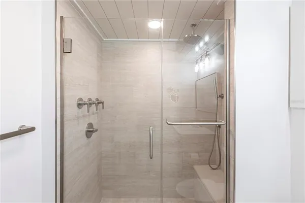 a bathroom with a glass shower door
