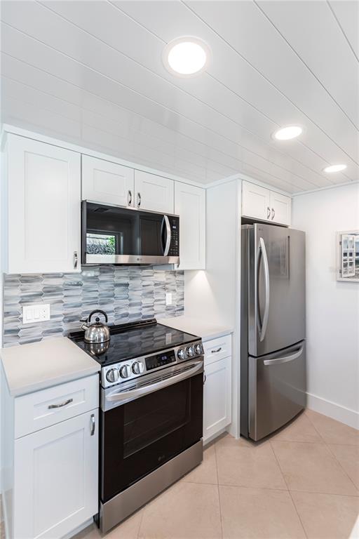 6154 Midnight Pass Road, Unit A1 Sarasota, FL 34242 - Photo 18 of 19 a kitchen with a stove microwave and refrigerator