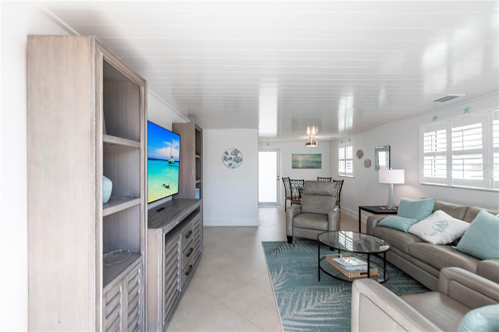 6154 Midnight Pass Road, Unit A1 Sarasota, FL 34242 - Photo 3 of 19 a room with furniture and a fireplace