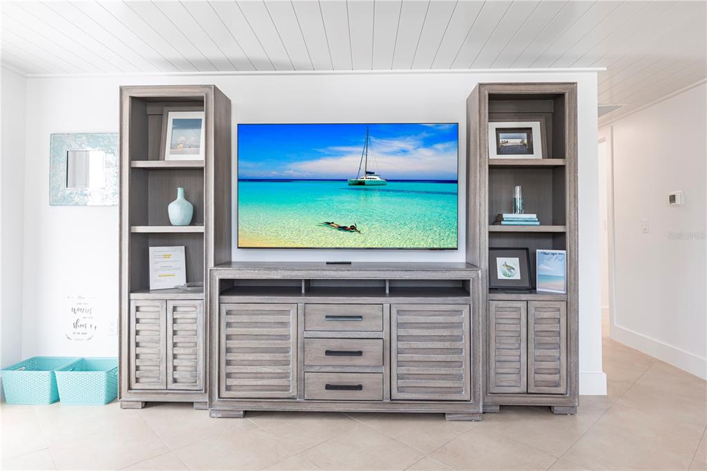 6154 Midnight Pass Road, Unit A1 Sarasota, FL 34242 - Photo 6 of 19 a living room with furniture and a flat screen tv