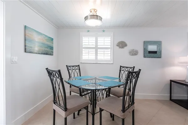 a view of a dining room with furniture and window