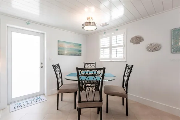 a view of a dining room with furniture and window