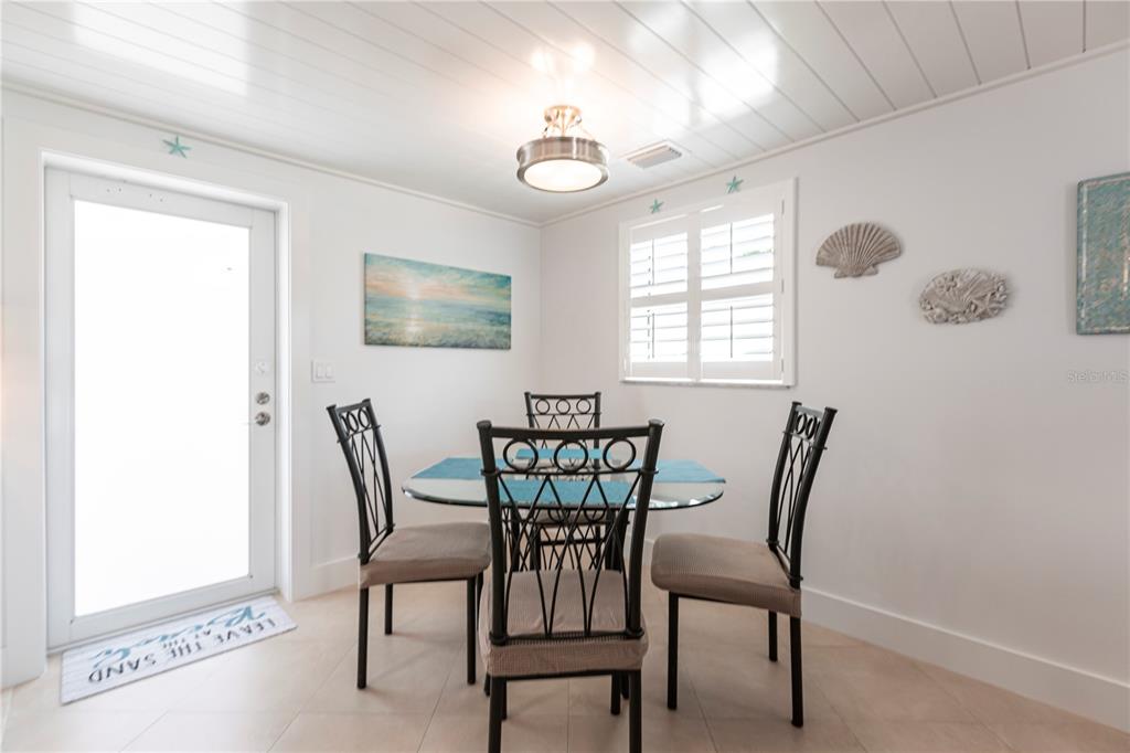 6154 Midnight Pass Road, Unit A1 Sarasota, FL 34242 - Photo 8 of 19 a view of a dining room with furniture and window