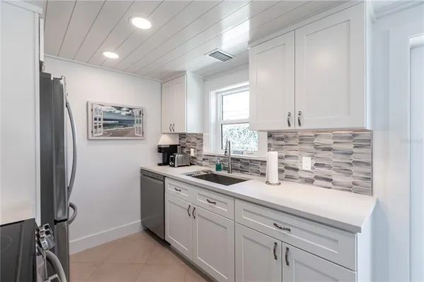 a kitchen with a sink stove and refrigerator
