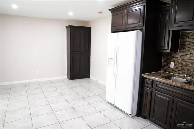 a kitchen with a sink and a refrigerator