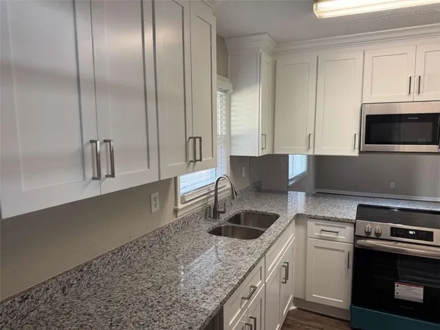 a kitchen that has a sink and a stove