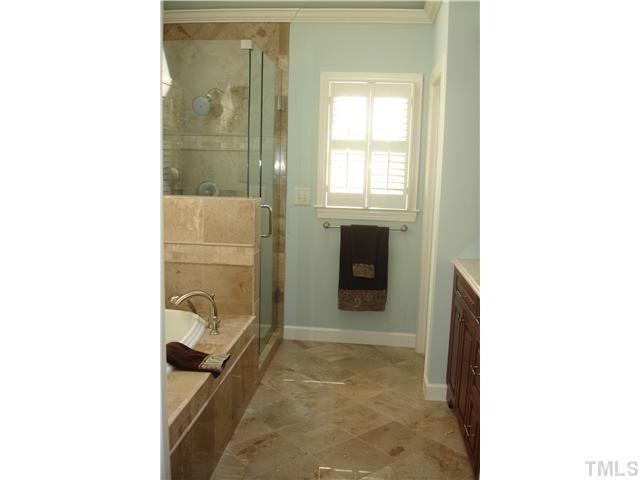 1921 Torrington Street Raleigh, NC 27615 - Photo 15 of 25 Everything has been renovated! Heated tile floors, new shower surround and fixtures, and a cathedral ceiling make this bathroom an oasis!