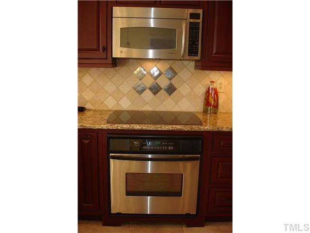 1921 Torrington Street Raleigh, NC 27615 - Photo 6 of 25 Decorative tile backsplash throughout the kitchen.