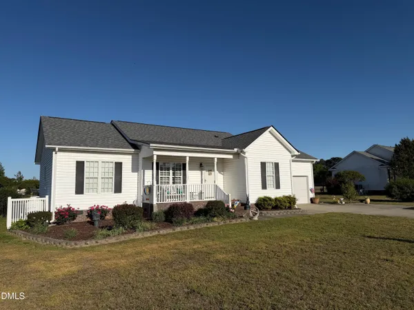 a front view of a house with a garden