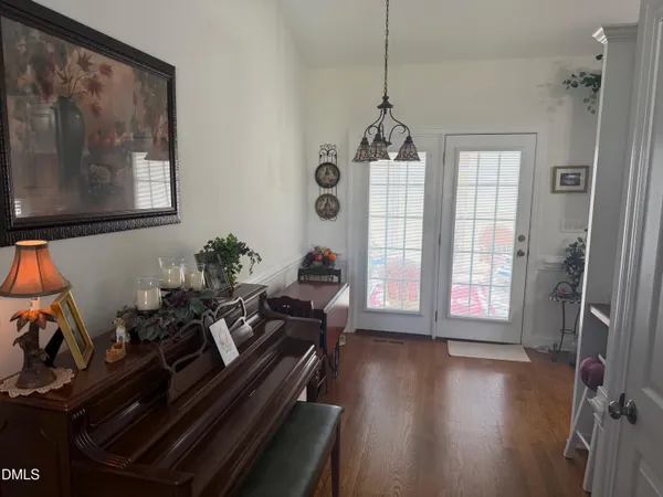 a room with gym equipment and wooden floor