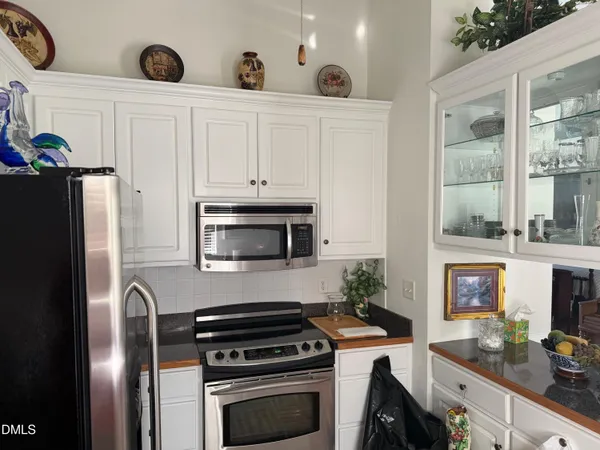 a kitchen with stainless steel appliances a stove a microwave and a refrigerator