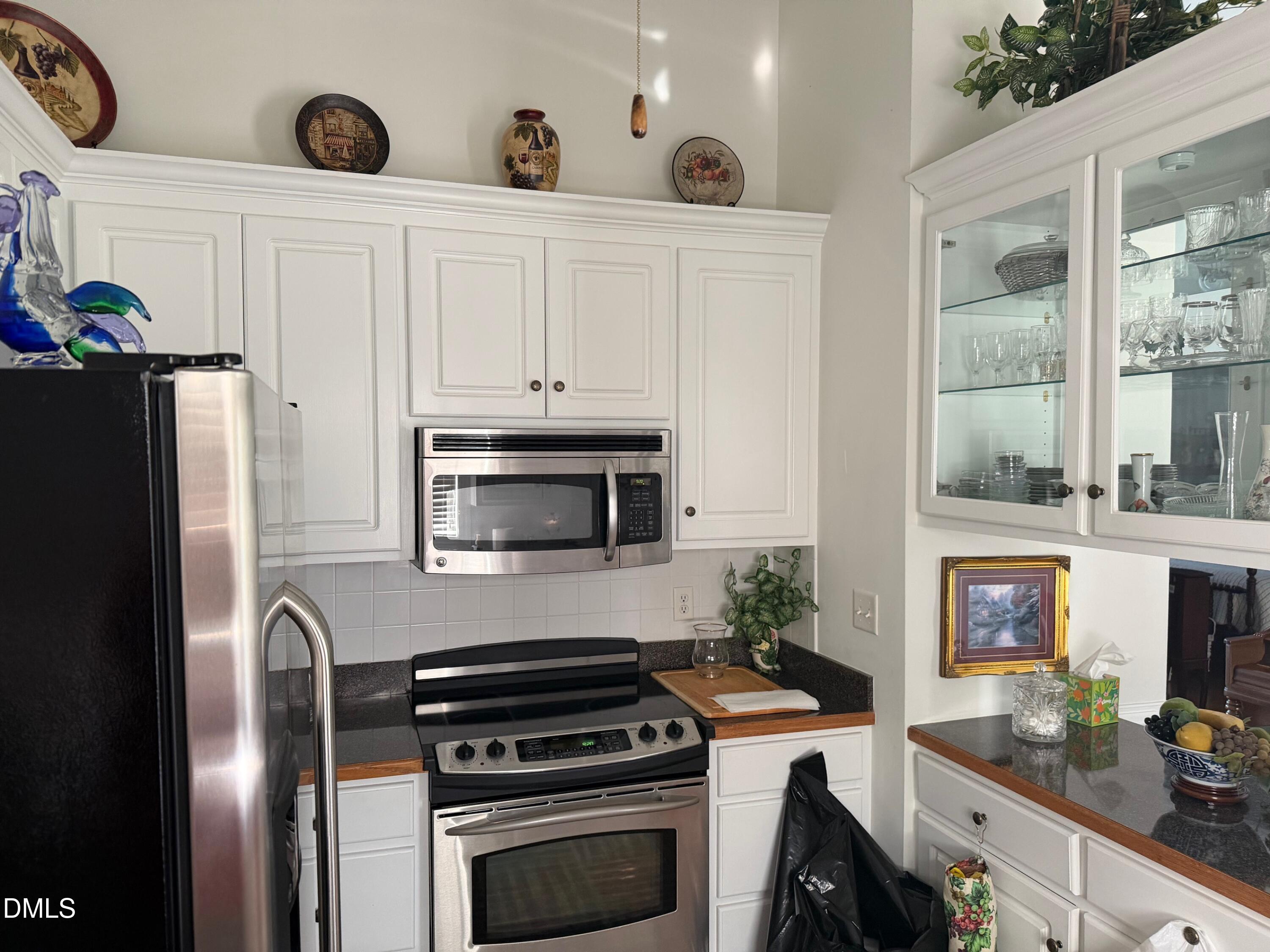 6949 Rock Ridge Sims Road Sims, NC 27880 - Photo 20 of 24 a kitchen with stainless steel appliances a stove a microwave and a refrigerator