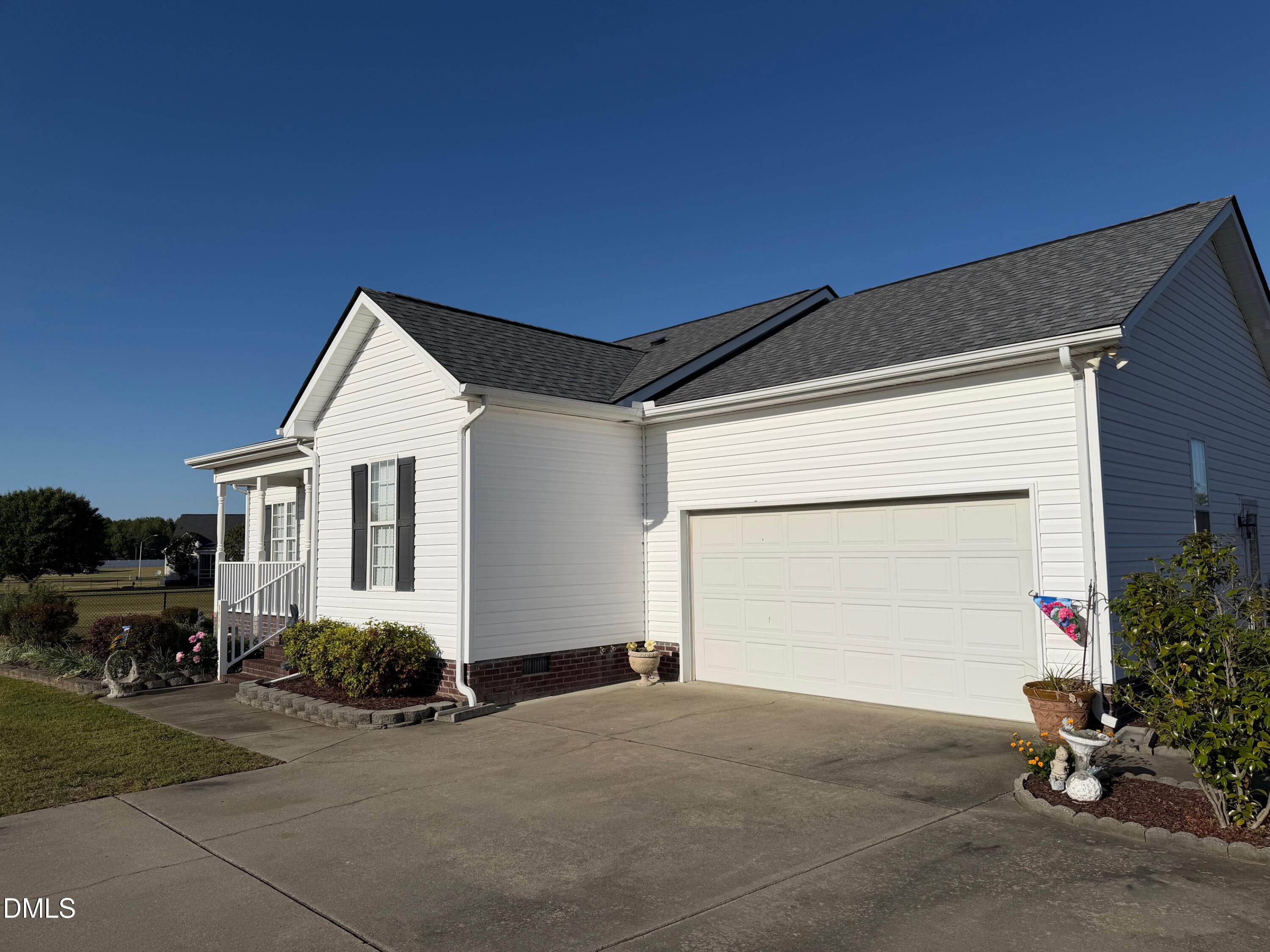 6949 Rock Ridge Sims Road Sims, NC 27880 - Photo 2 of 24 a front view of a house with a yard and garage
