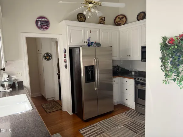 a kitchen with stainless steel appliances granite countertop a refrigerator and a stove