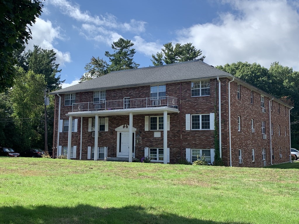 424 Great Road, Unit 2 Acton, MA 01720 - Photo 10 of 13 front view of a brick house with a yard