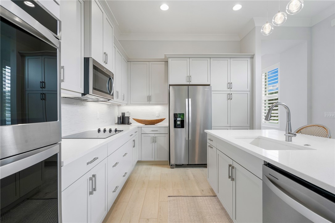2159 Falls Manor Vero Beach, FL 32967 - Photo 13 of 36 a kitchen with a sink a refrigerator and a stove