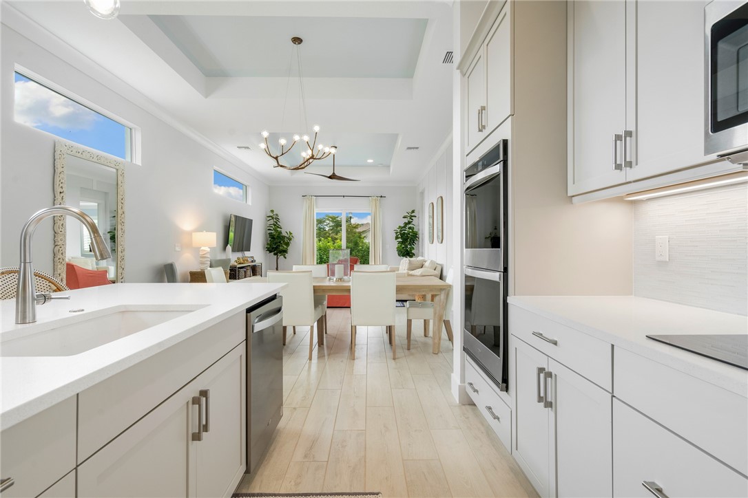 2159 Falls Manor Vero Beach, FL 32967 - Photo 14 of 36 a very nice looking dining room with kitchen island a large window a sink and a refrigerator