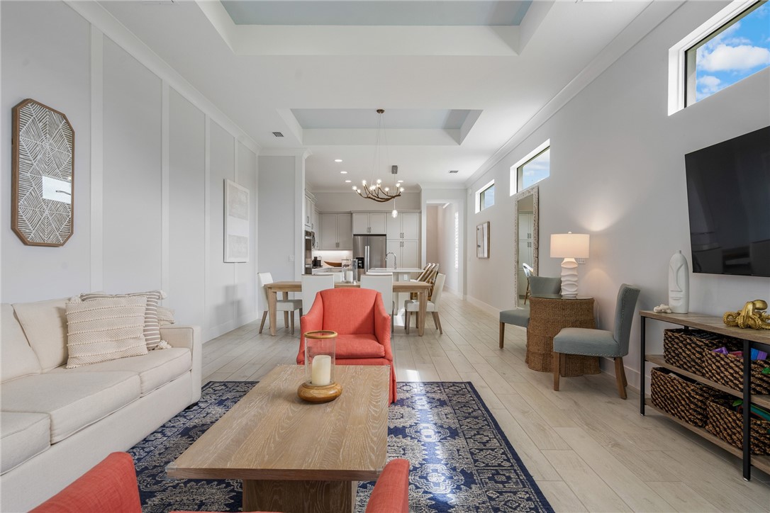 2159 Falls Manor Vero Beach, FL 32967 - Photo 21 of 36 a living room with furniture a flat screen tv and kitchen view