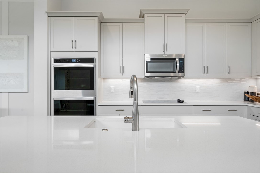 2159 Falls Manor Vero Beach, FL 32967 - Photo 23 of 36 a kitchen with granite countertop white cabinets and stainless steel appliances