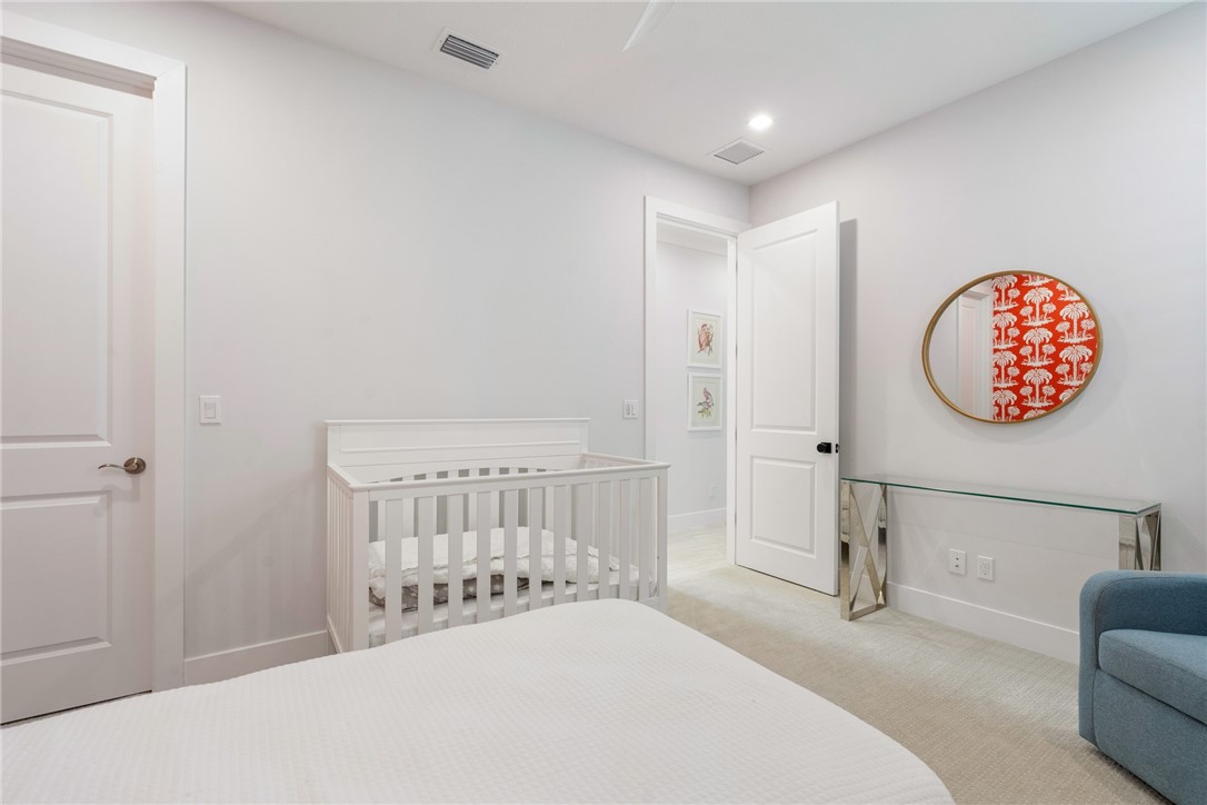 2159 Falls Manor Vero Beach, FL 32967 - Photo 30 of 36 a bedroom with a bed and a chair