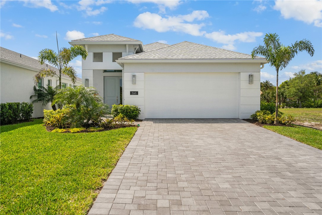 2159 Falls Manor Vero Beach, FL 32967 - Photo 34 of 36 a front view of a house with a garden