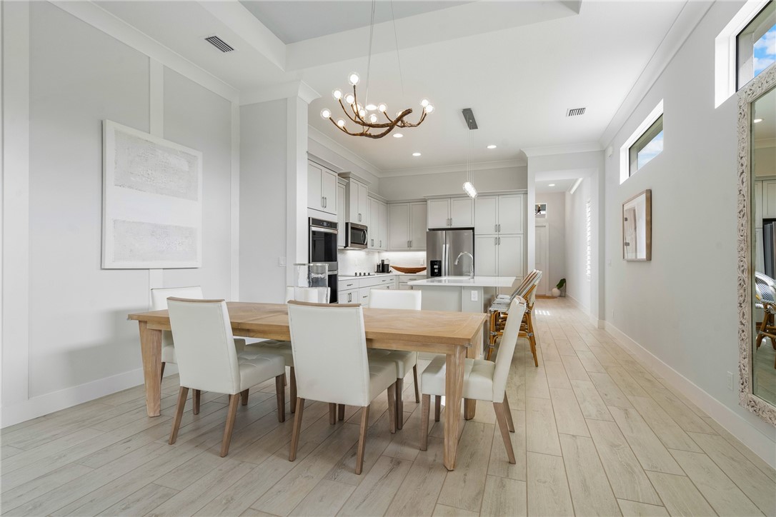 2159 Falls Manor Vero Beach, FL 32967 - Photo 7 of 36 a view of a dining room with furniture and wooden floor