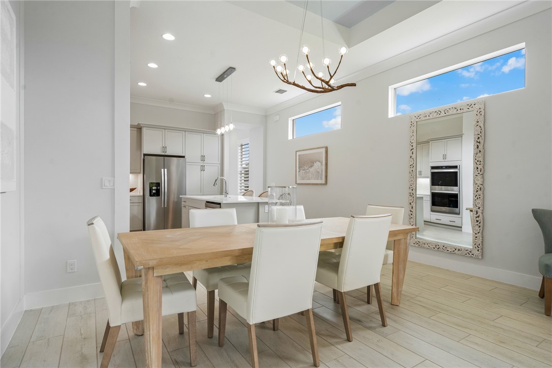 2159 Falls Manor Vero Beach, FL 32967 - Photo 9 of 36 a view of a dining room with furniture a chandelier and wooden floor